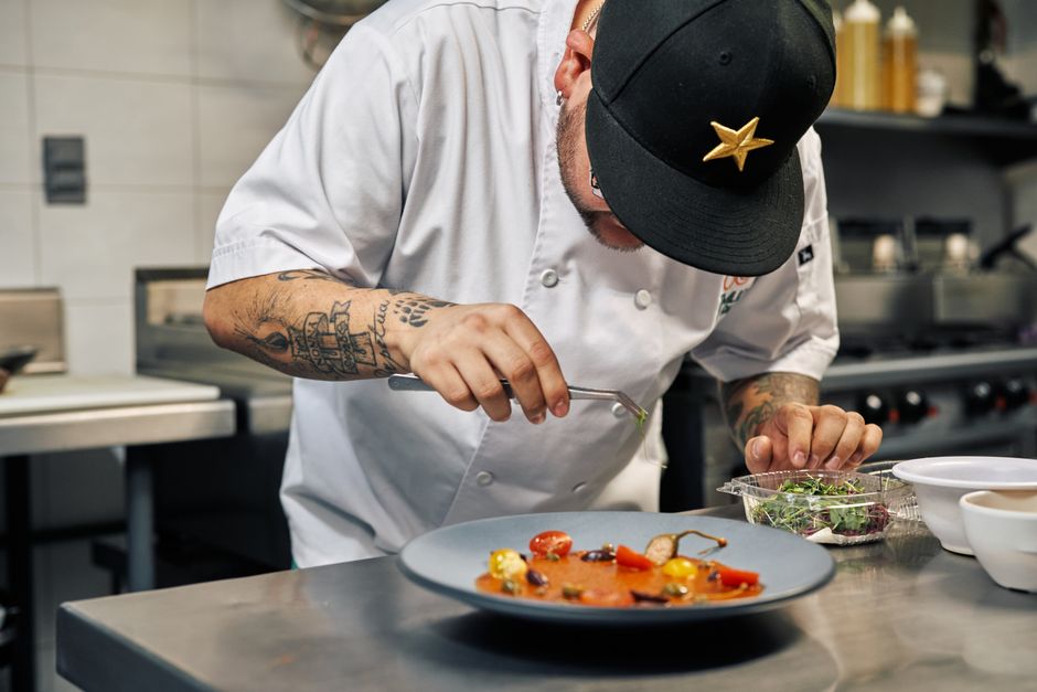 Professional chef meticulously plating gourmet food