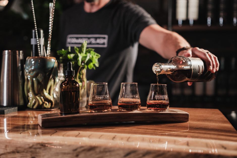 Bartender pouring craft cocktails at a corporate event